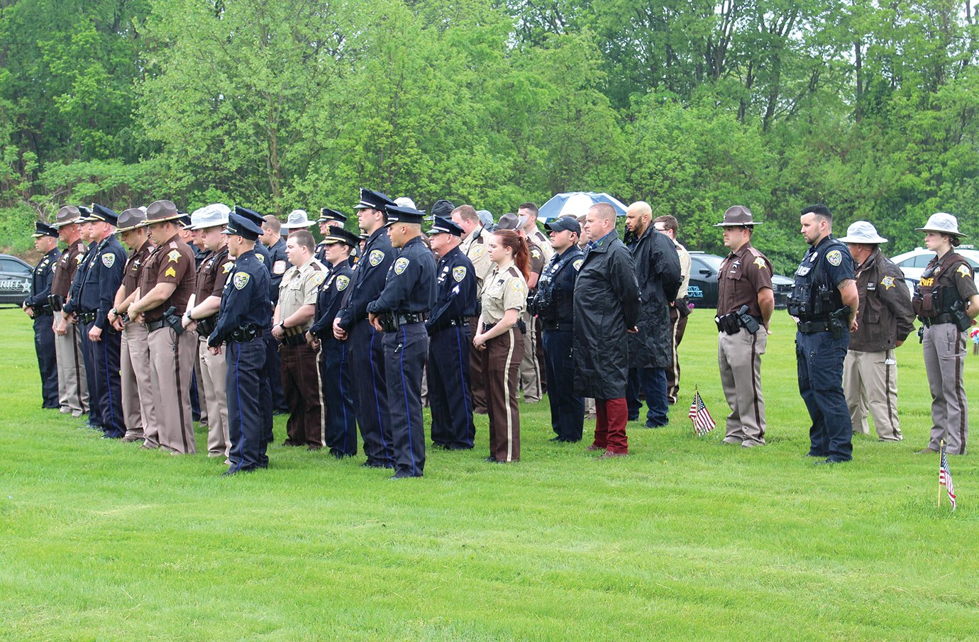 Family, friends and fellow law enforcement of the late Russell Baldwin honor the fallen officer Wednesday at Oak Hill Cemetery.
